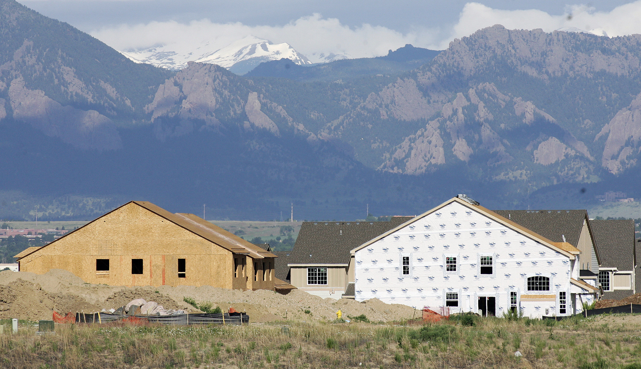 Mountains in the background of a housing development that is under construction.