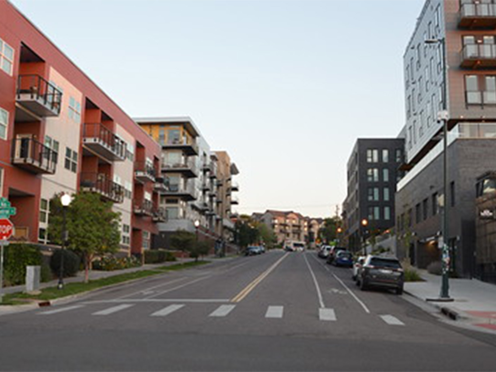 An urban setting in Colorado with residential and commercial buildings lining a street.