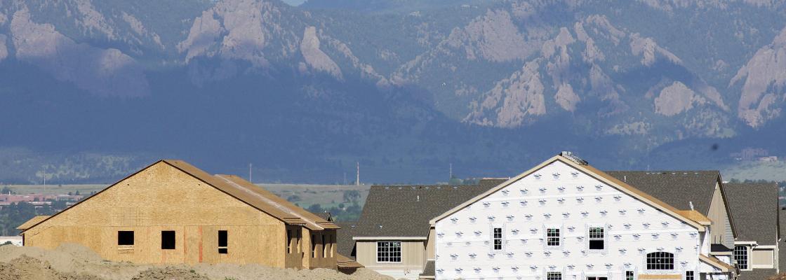 Mountains in the background of a housing development that is under construction.
