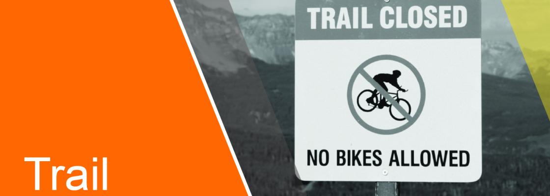 A trail closed sign that says "no bikes allowed" is shown in greyscale