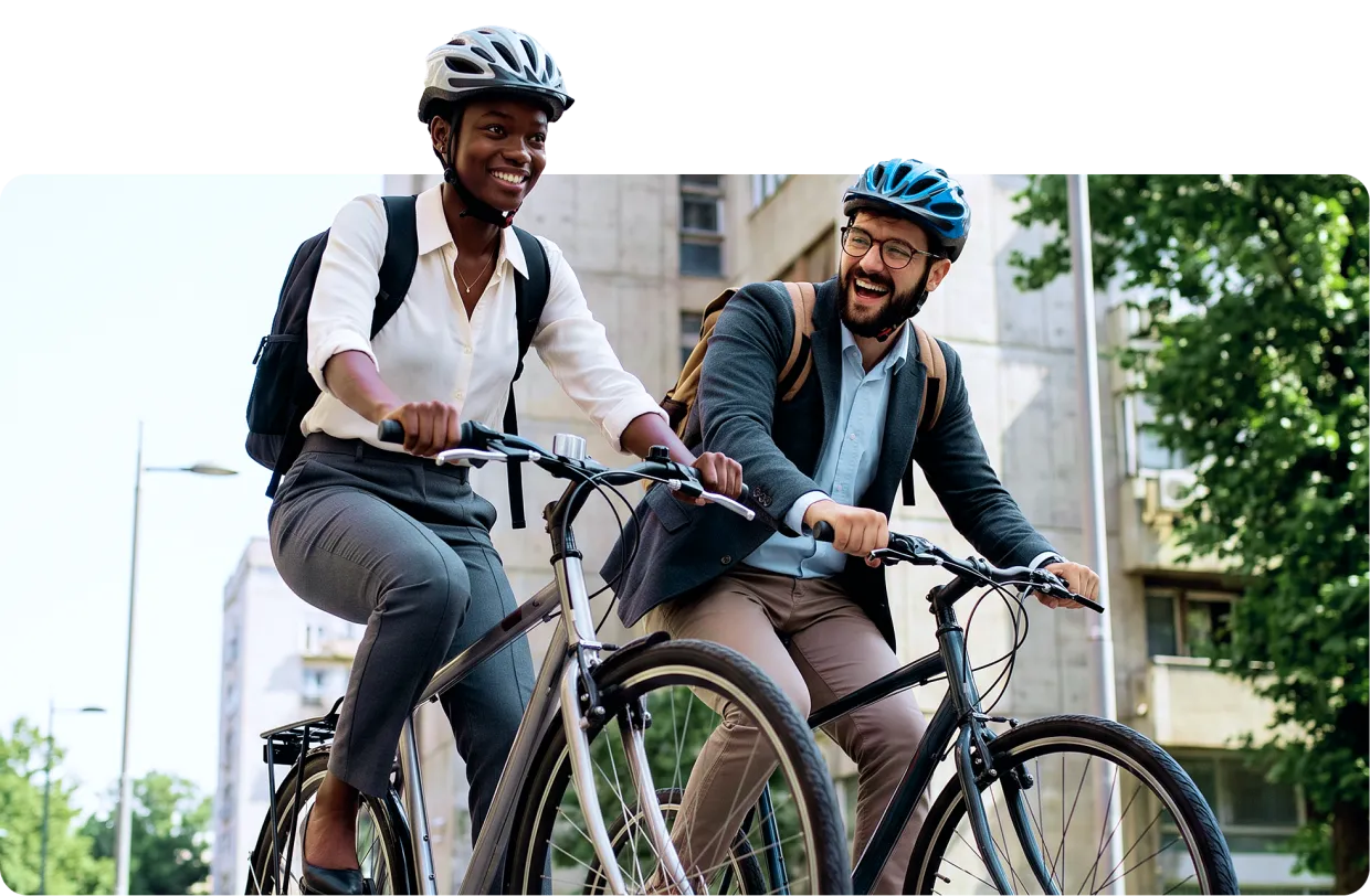 Two young professionals having a friendly race as they bike to work.